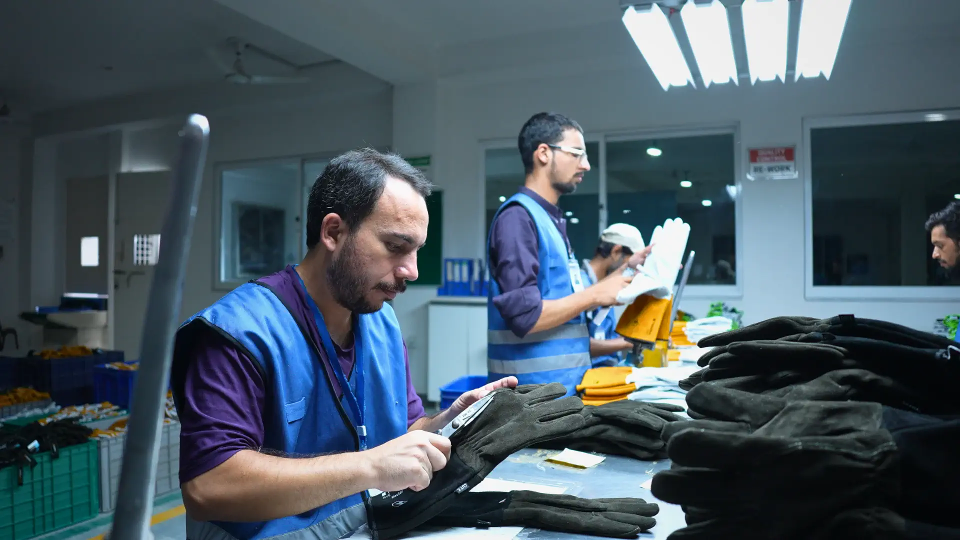 Protective gloves undergoing finishing operations