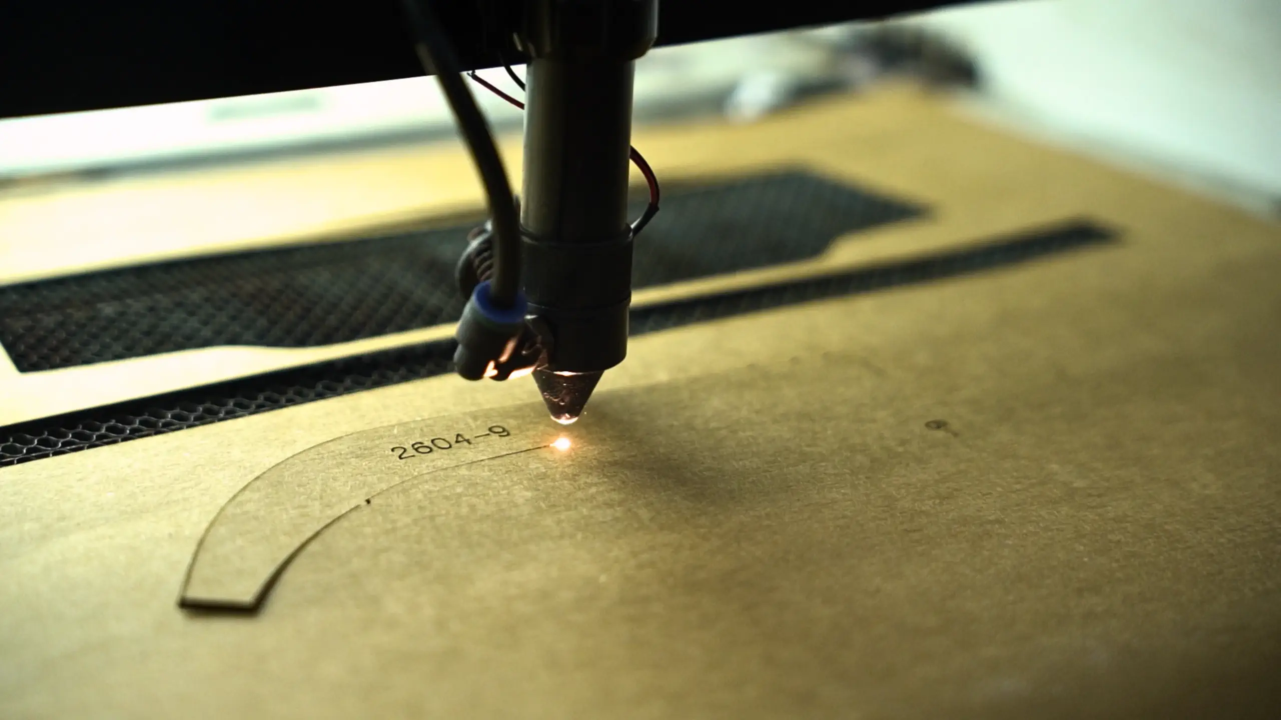Hands positioning material layers on a work surface