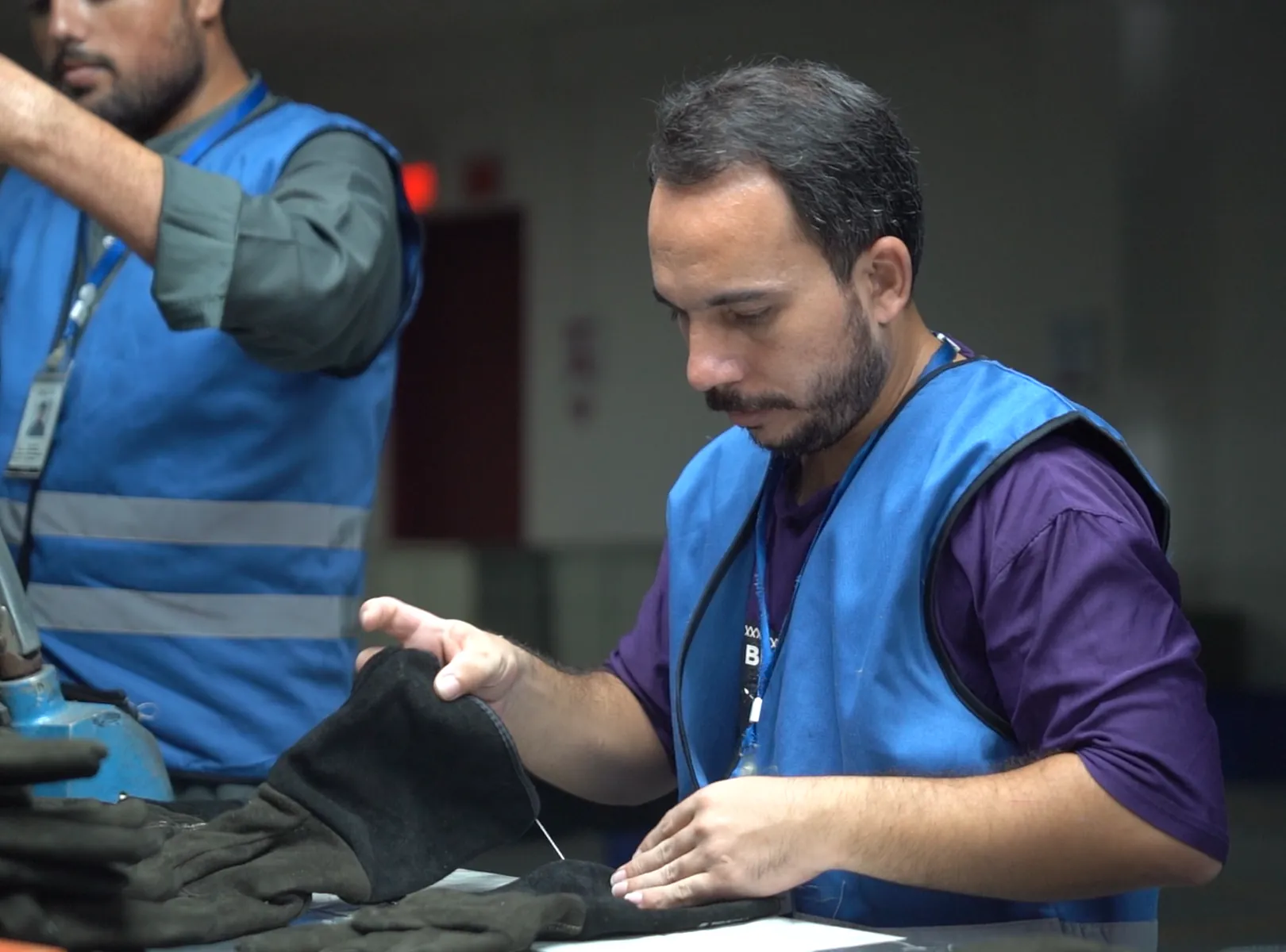 Emblon employees inspecting protective gloves